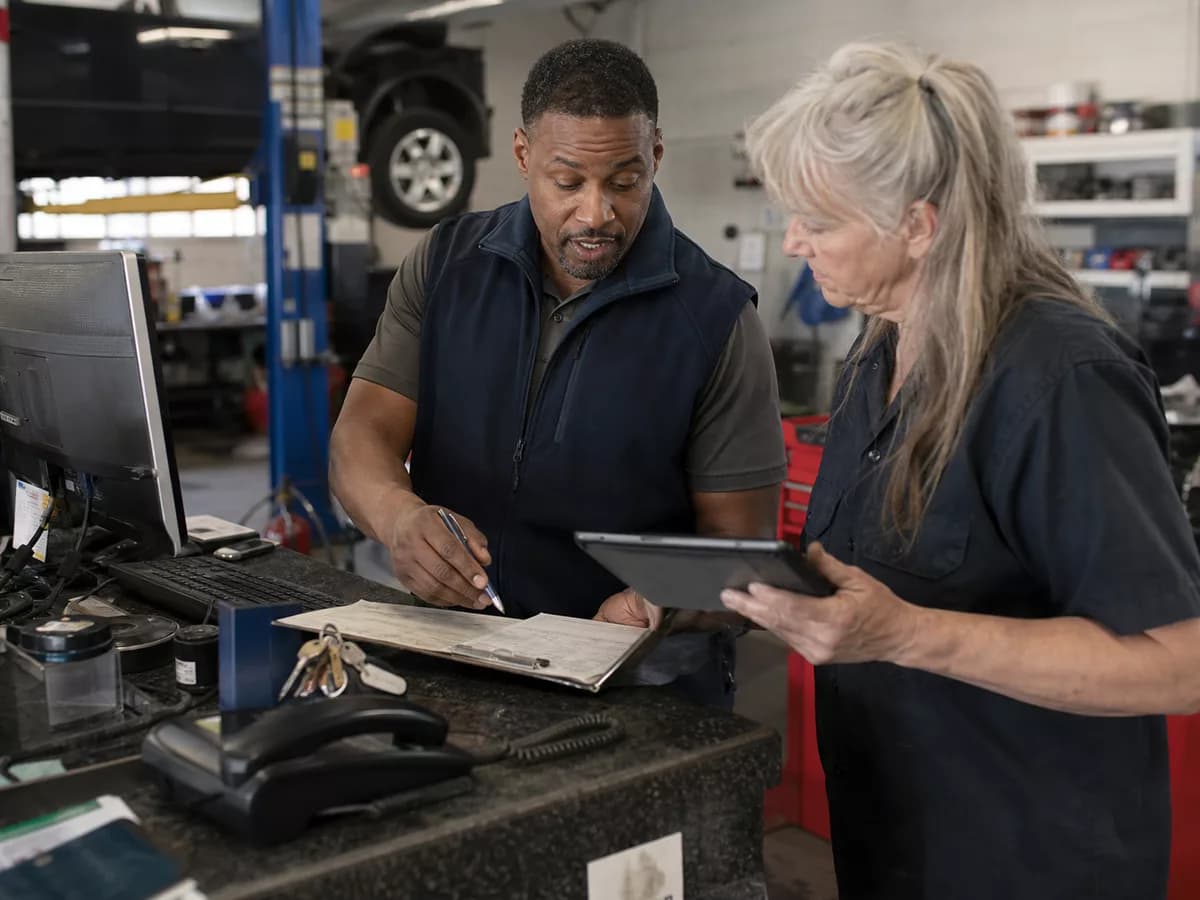 Automotive workshop team coordinating service requests with Kelvia.