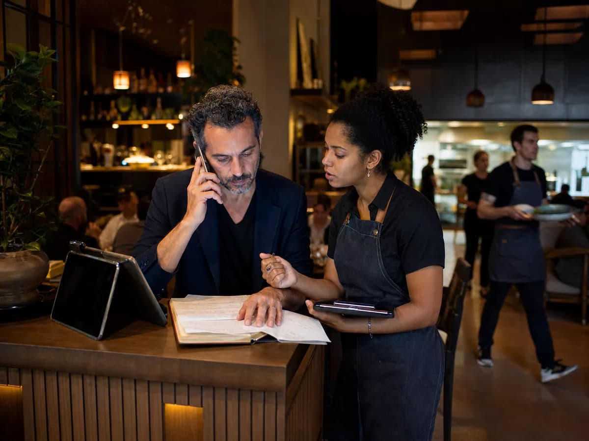 Restaurant team handling service while Kelvia captures reservation work.